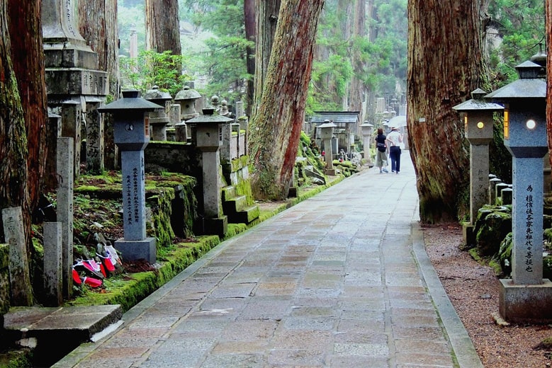 The walking path through Okunoin Cemetery at Koyasan, with a couple of people walk ahead