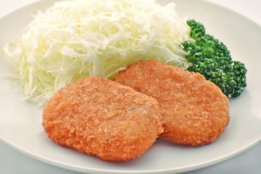 Japanese croquettes, known as "korokke," are popular and delicious deep-fried food items with a rich culinary history. Made from mashed potatoes, ground meat (commonly beef or pork), vegetables, and seasoning, they are coated with breadcrumbs before frying. Korokke can be found in various flavors like curry, shrimp, or cheese, catering to diverse tastes. Often served as appetizers, side dishes, or in bento boxes, they are enjoyed by people of all ages in Japan. Their crispy exterior and flavorful fillings make them a beloved comfort food, combining Western influences with Japanese culinary finesse.