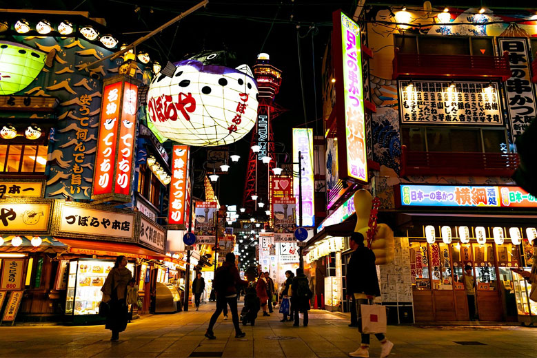 Shinsekai District in Osaka at night, with the Tsutenkaku Tower illuminated in the back